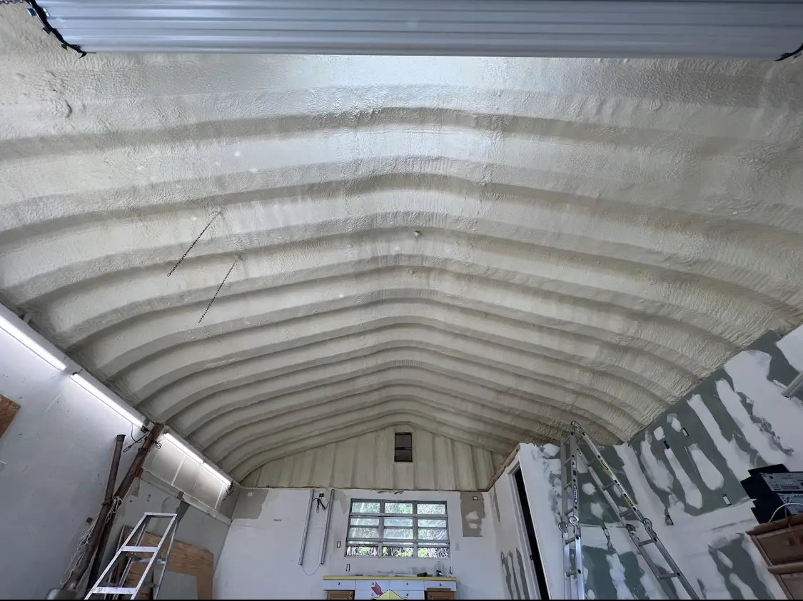 Spray polyurethane foam applied to the underside of a metal roof deck in Roswell